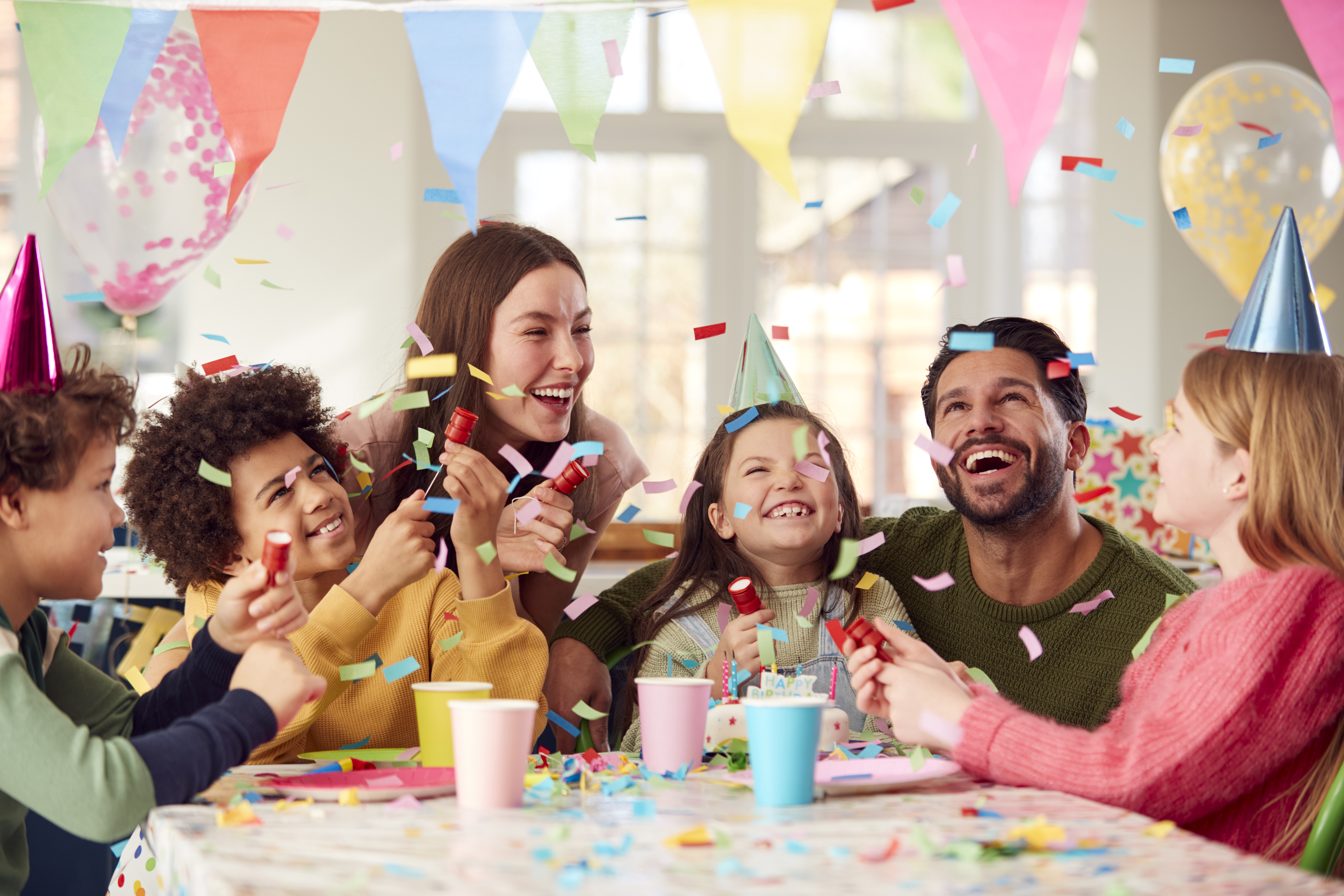 girl with parents celebrating birthday party